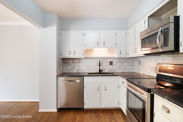6503 Deep Creek Dr Unit 1, Prospect, KY 40059 - kitchen featuring appliances with stainless steel finishes, decorative backsplash, dark countertops, and white cabinets