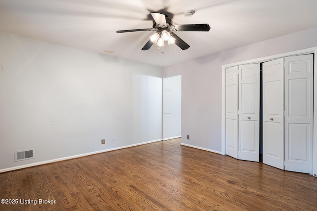 6503 Deep Creek Dr Unit 1, Prospect, KY 40059 - unfurnished bedroom with dark wood-style flooring, a closet, and a ceiling fan