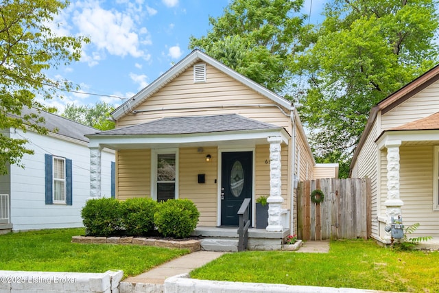 631 Lynn St, Louisville, KY 40217 - shotgun-style home with a shingled roof and covered porch