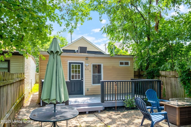 631 Lynn St, Louisville, KY 40217 - back of property featuring a deck, a fenced backyard, and a patio