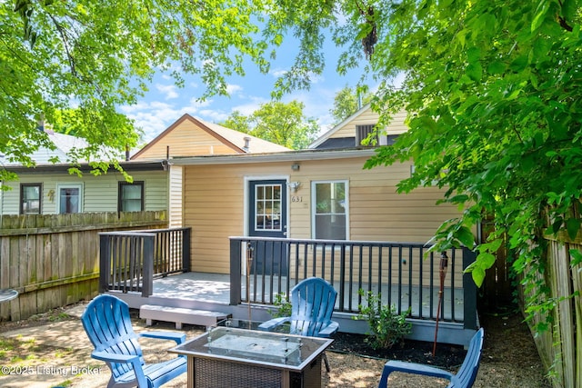 631 Lynn St, Louisville, KY 40217 - back of house featuring a wooden deck and an outdoor fire pit
