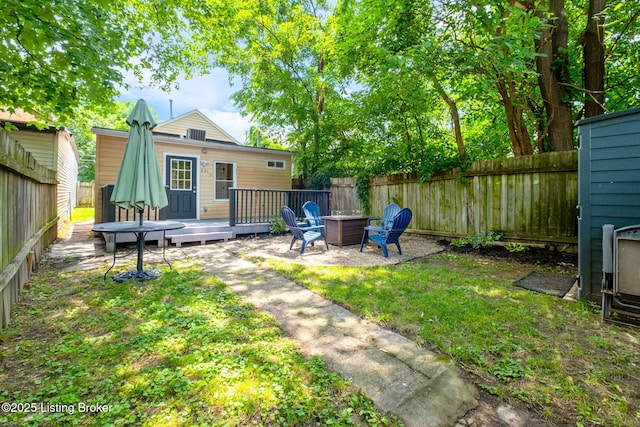 631 Lynn St, Louisville, KY 40217 - fenced backyard with a deck and an outdoor fire pit