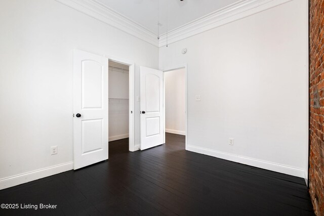 631 Lynn St, Louisville, KY 40217 - unfurnished bedroom featuring dark wood-style flooring, crown molding, and a closet