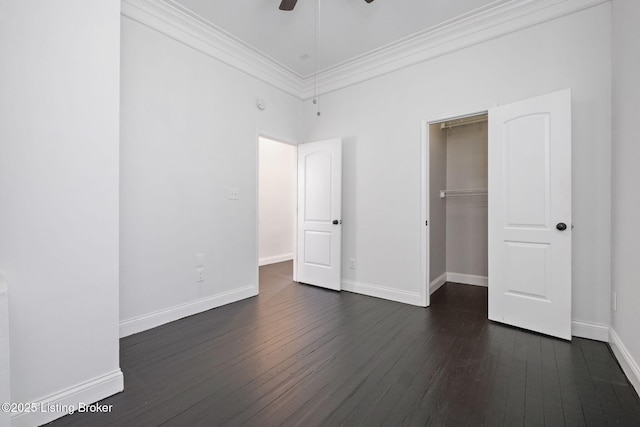631 Lynn St, Louisville, KY 40217 - unfurnished bedroom featuring ornamental molding, dark wood-type flooring, a closet, a ceiling fan, and a spacious closet