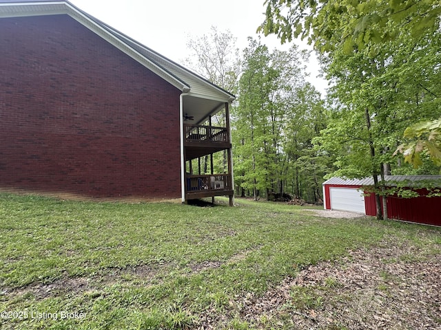 68 Lonnie Lawson Ct, Brandenburg, KY 40108 - view of grassy yard featuring ceiling fan, an outdoor structure, and a garage