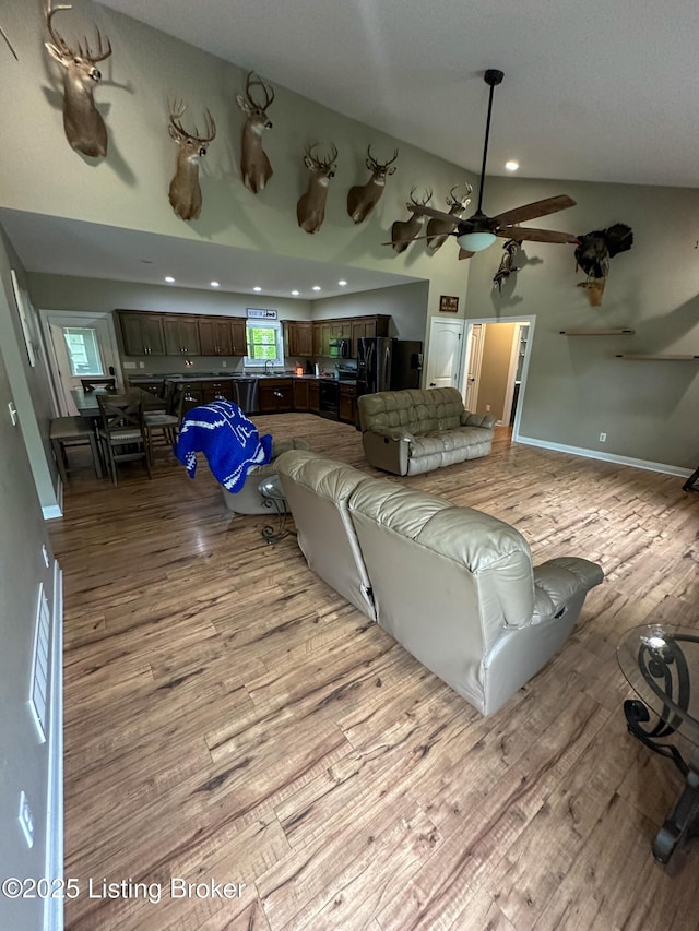 68 Lonnie Lawson Ct, Brandenburg, KY 40108 - living room featuring light wood-type flooring, a ceiling fan, recessed lighting, and vaulted ceiling