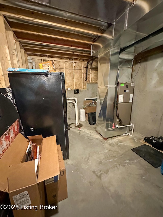 68 Lonnie Lawson Ct, Brandenburg, KY 40108 - unfinished below grade area featuring freestanding refrigerator, heating unit, and drainage system