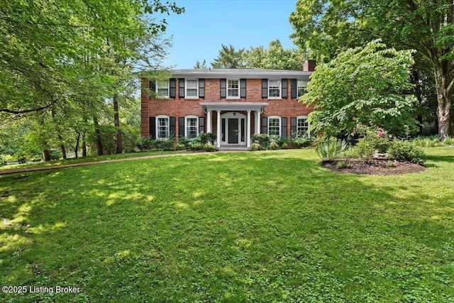 5612 Apache Rd, Louisville, KY 40207 - colonial home featuring brick siding, a front yard, and a chimney