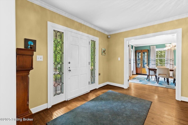 5612 Apache Rd, Louisville, KY 40207 - foyer entrance featuring a chandelier, crown molding, and wood finished floors