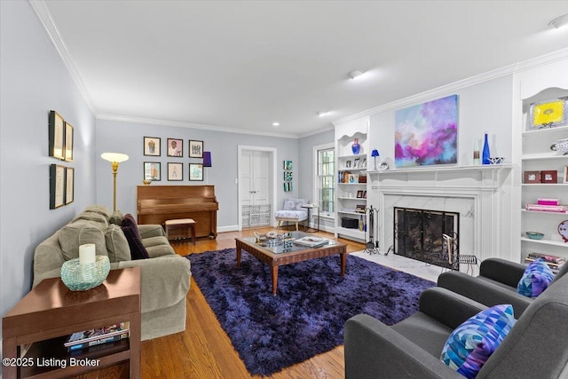 5612 Apache Rd, Louisville, KY 40207 - living area with crown molding, wood finished floors, a high end fireplace, built in features, and recessed lighting