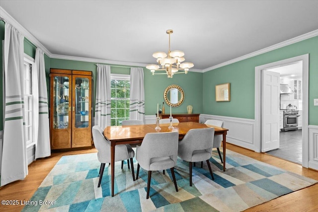 5612 Apache Rd, Louisville, KY 40207 - dining area featuring a chandelier, crown molding, wood finished floors, and wainscoting