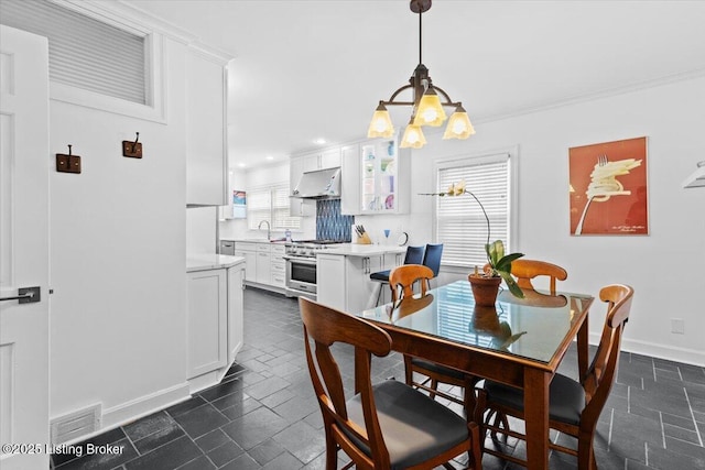 5612 Apache Rd, Louisville, KY 40207 - dining area with a chandelier, crown molding, and recessed lighting