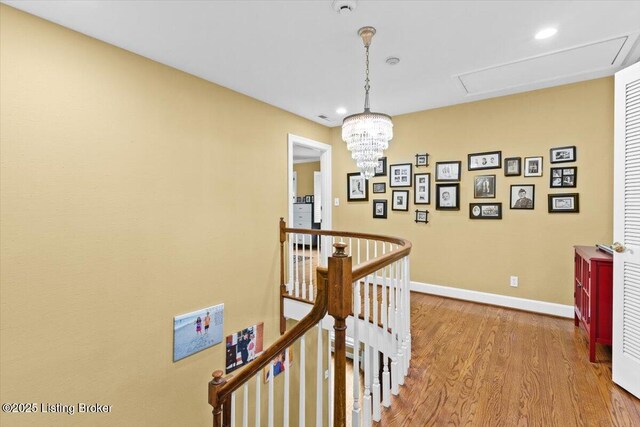 5612 Apache Rd, Louisville, KY 40207 - corridor featuring an upstairs landing, wood finished floors, attic access, recessed lighting, and a chandelier