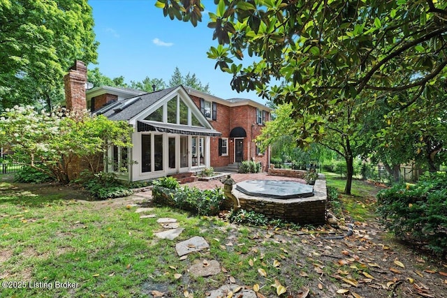 5612 Apache Rd, Louisville, KY 40207 - rear view of house featuring brick siding, a chimney, and a sunroom