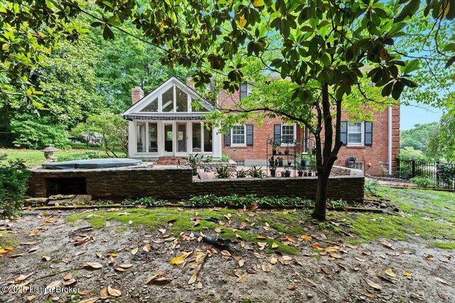 5612 Apache Rd, Louisville, KY 40207 - back of property featuring a chimney, brick siding, and a patio
