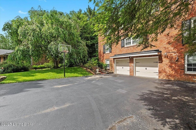 5612 Apache Rd, Louisville, KY 40207 - view of property exterior with driveway, brick siding, a lawn, and a garage