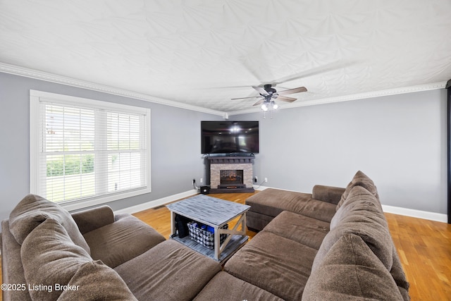 192 Loretto Rd, Springfield, KY 40069 - living room with ceiling fan, a stone fireplace, wood finished floors, and crown molding