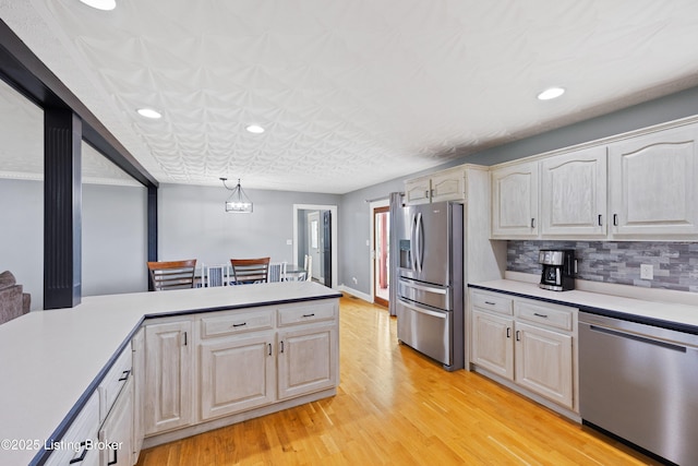 192 Loretto Rd, Springfield, KY 40069 - kitchen featuring stainless steel appliances, light countertops, light wood-style flooring, recessed lighting, and tasteful backsplash