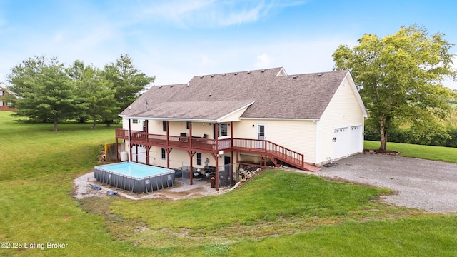 192 Loretto Rd, Springfield, KY 40069 - rear view of house featuring a wooden deck, a hot tub, a garage, roof with shingles, and a lawn