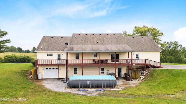 192 Loretto Rd, Springfield, KY 40069 - back of house featuring a wooden deck, an attached garage, a yard, an outdoor pool, and driveway