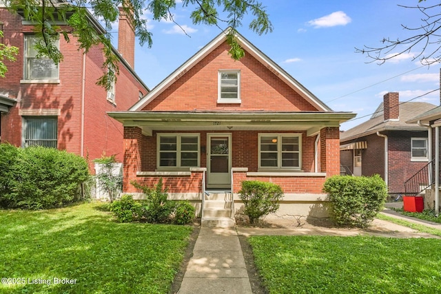1721 S 4th St, Louisville, KY 40208 - bungalow-style home with brick siding, a porch, and a front lawn