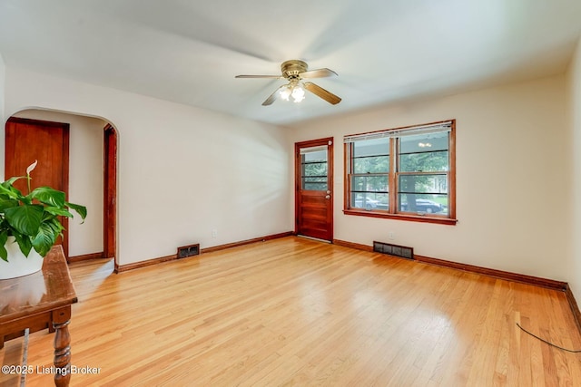 1721 S 4th St, Louisville, KY 40208 - spare room with ceiling fan, light wood finished floors, and arched walkways