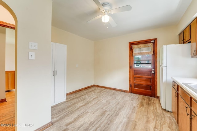 1721 S 4th St, Louisville, KY 40208 - kitchen with light wood-style floors, a ceiling fan, light countertops, arched walkways, and freestanding refrigerator