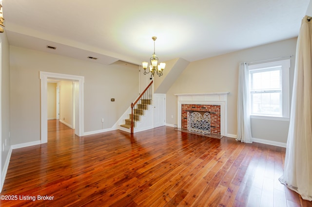 2990 Cedar Grove Rd, Shepherdsville, KY 40165 - unfurnished living room with a chandelier, hardwood / wood-style floors, stairs, and a brick fireplace