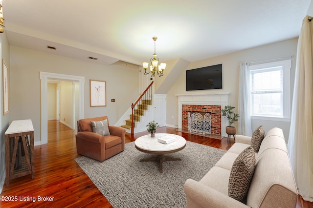 2990 Cedar Grove Rd, Shepherdsville, KY 40165 - living room featuring a chandelier, dark wood-type flooring, stairs, and a fireplace