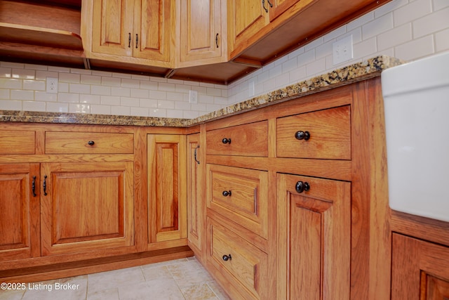 2990 Cedar Grove Rd, Shepherdsville, KY 40165 - kitchen view of stone counters, decorative backsplash, and brown cabinetry