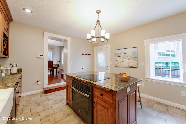 2990 Cedar Grove Rd, Shepherdsville, KY 40165 - kitchen featuring black appliances, brown cabinets, a chandelier, light stone finish flooring, and recessed lighting