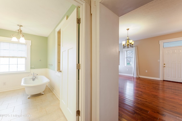 2990 Cedar Grove Rd, Shepherdsville, KY 40165 - bathroom with a chandelier, a freestanding tub, and wood finished floors