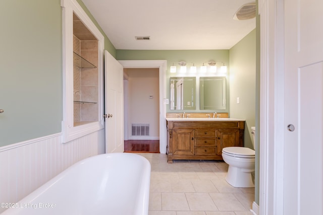 2990 Cedar Grove Rd, Shepherdsville, KY 40165 - bathroom featuring a freestanding bath, double vanity, tile patterned floors, and a wainscoted wall
