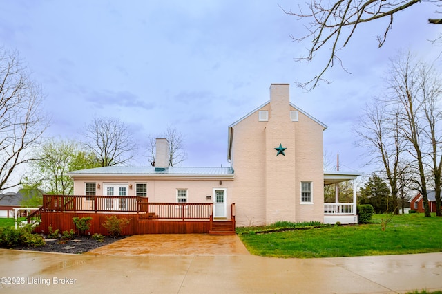 2990 Cedar Grove Rd, Shepherdsville, KY 40165 - view of home's exterior featuring a chimney, a deck, a yard, and a metal roof