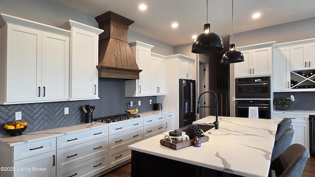 6015 St Bernadette Ave, Prospect, KY 40059 - kitchen with black appliances, white cabinetry, decorative backsplash, a kitchen island with sink, and hanging light fixtures
