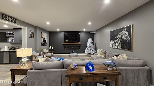 6015 St Bernadette Ave, Prospect, KY 40059 - living room with light wood-type flooring, recessed lighting, wet bar, and a glass covered fireplace