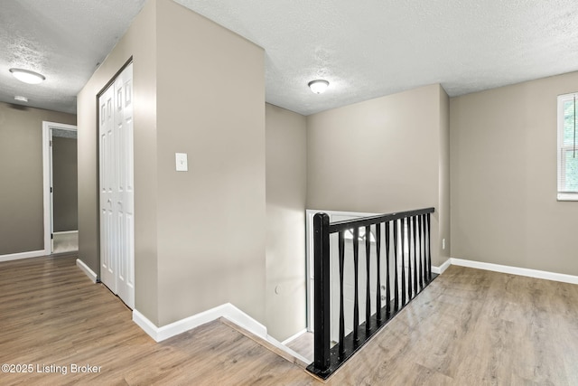 3619 Endeavor Way, Louisville, KY 40219 - corridor with a textured ceiling, an upstairs landing, and wood finished floors