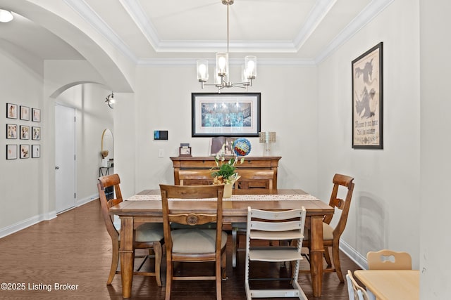 13420 Cain Ln, Louisville, KY 40245 - dining space with arched walkways, a chandelier, dark wood-style flooring, a raised ceiling, and crown molding