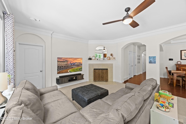 13420 Cain Ln, Louisville, KY 40245 - living area with a ceiling fan, arched walkways, crown molding, a tile fireplace, and wood finished floors