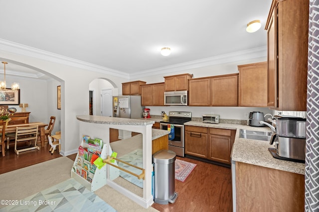 13420 Cain Ln, Louisville, KY 40245 - kitchen featuring stainless steel appliances, brown cabinets, ornamental molding, arched walkways, and dark wood-style floors