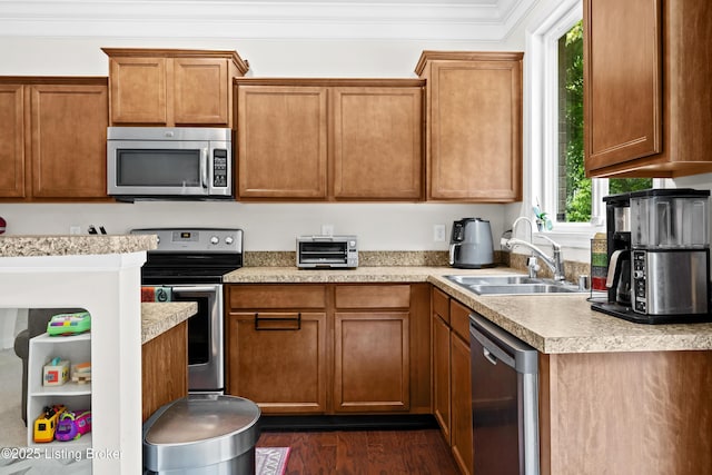 13420 Cain Ln, Louisville, KY 40245 - kitchen featuring appliances with stainless steel finishes, light countertops, crown molding, dark wood-style floors, and brown cabinets