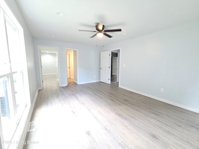 342 E Southside Ct, Louisville, KY 40214 - unfurnished bedroom with wood finished floors, a walk in closet, and a ceiling fan