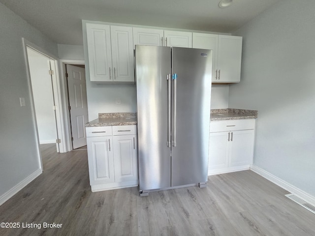 342 E Southside Ct, Louisville, KY 40214 - kitchen featuring high end refrigerator, light wood finished floors, white cabinetry, and light countertops