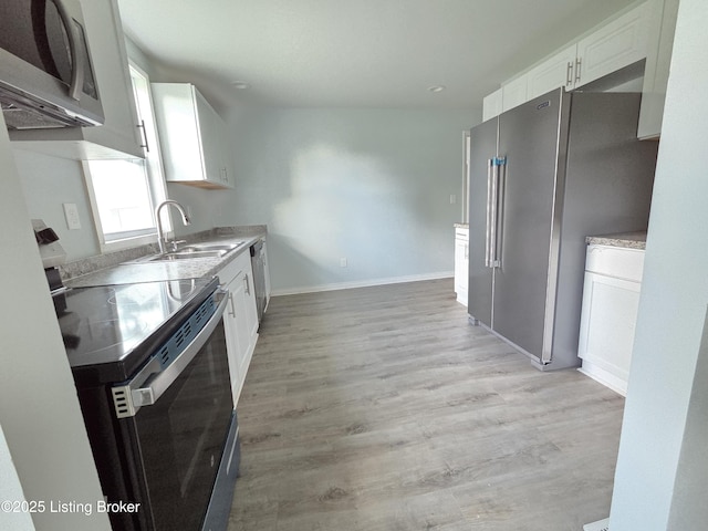 342 E Southside Ct, Louisville, KY 40214 - kitchen with appliances with stainless steel finishes, white cabinets, light wood-style floors, light countertops, and recessed lighting