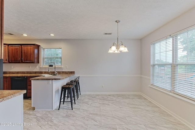 152 Glen Ridge Dr, Mt Washington, KY 40047 - kitchen featuring a kitchen breakfast bar, black dishwasher, a textured ceiling, a peninsula, and a chandelier