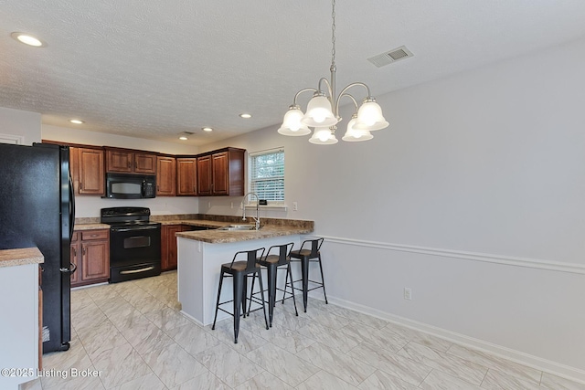 152 Glen Ridge Dr, Mt Washington, KY 40047 - kitchen with black appliances, a peninsula, a breakfast bar area, a chandelier, and recessed lighting