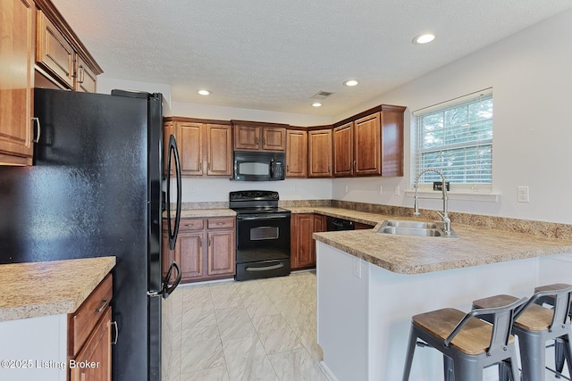 152 Glen Ridge Dr, Mt Washington, KY 40047 - kitchen featuring black appliances, a peninsula, light marble finish floors, recessed lighting, and a kitchen breakfast bar
