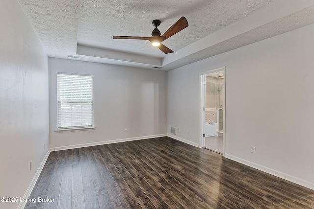 152 Glen Ridge Dr, Mt Washington, KY 40047 - spare room with a textured ceiling, dark wood-style flooring, ceiling fan, and a raised ceiling