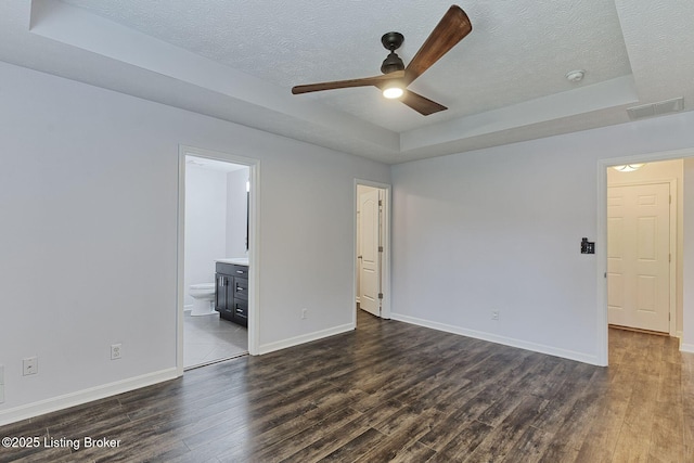 152 Glen Ridge Dr, Mt Washington, KY 40047 - empty room with a textured ceiling, ceiling fan, dark wood finished floors, and a raised ceiling