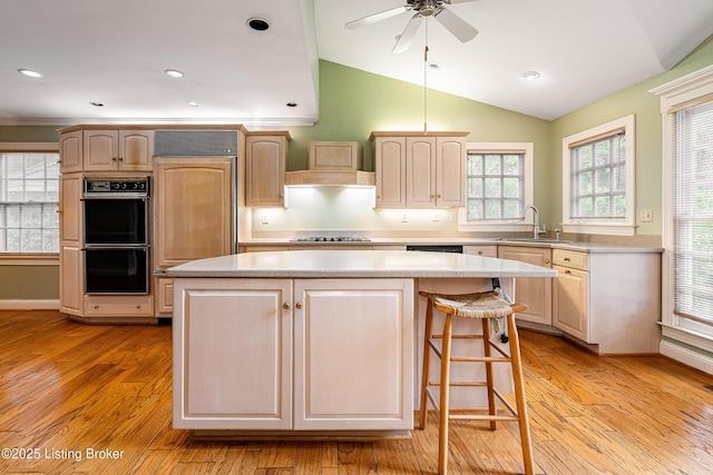 3920 Elfin Ave, Louisville, KY 40207 - kitchen featuring black appliances, a center island, light countertops, custom range hood, and light wood finished floors